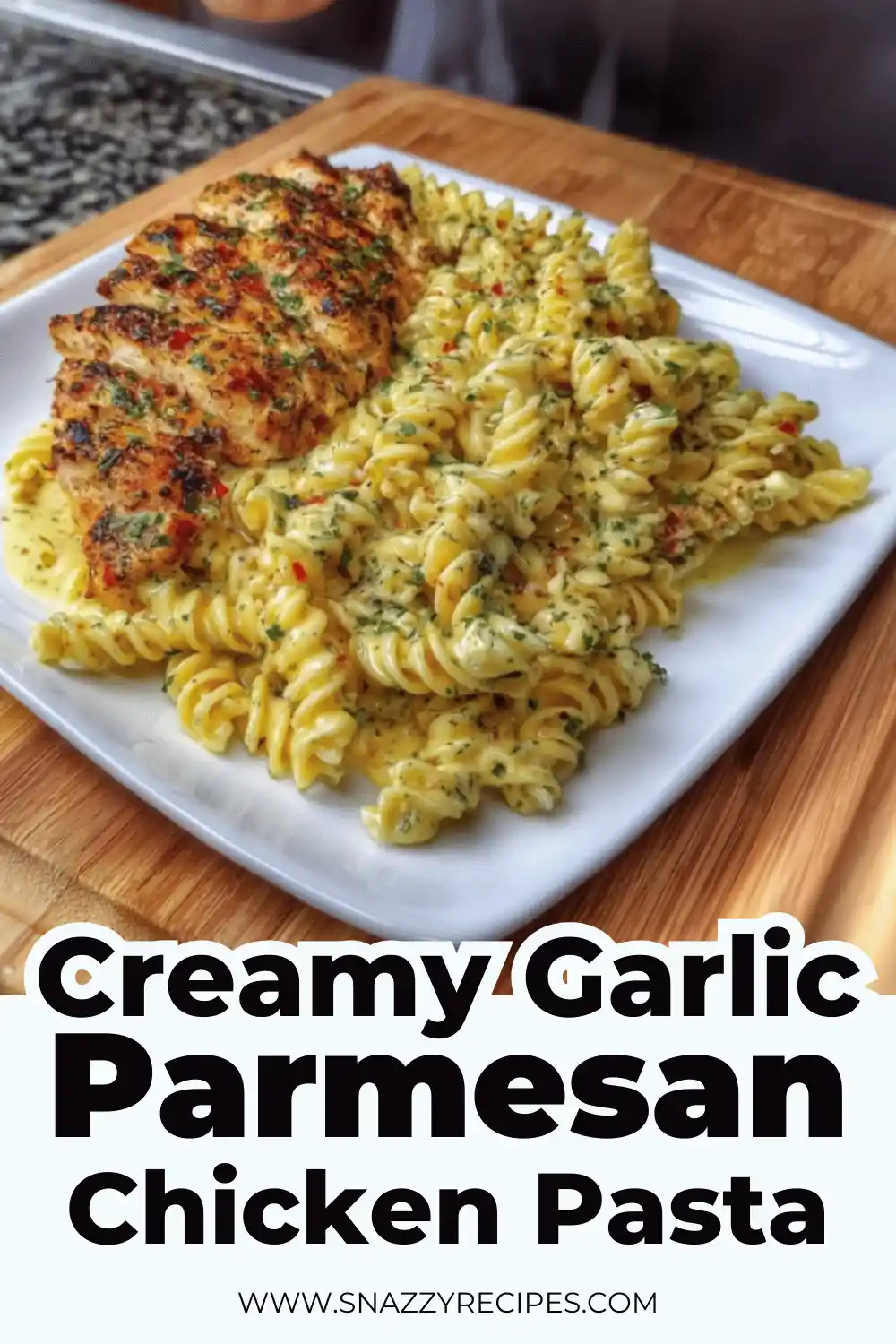 Bowl of garlic Parmesan chicken pasta with fork twirling noodles.