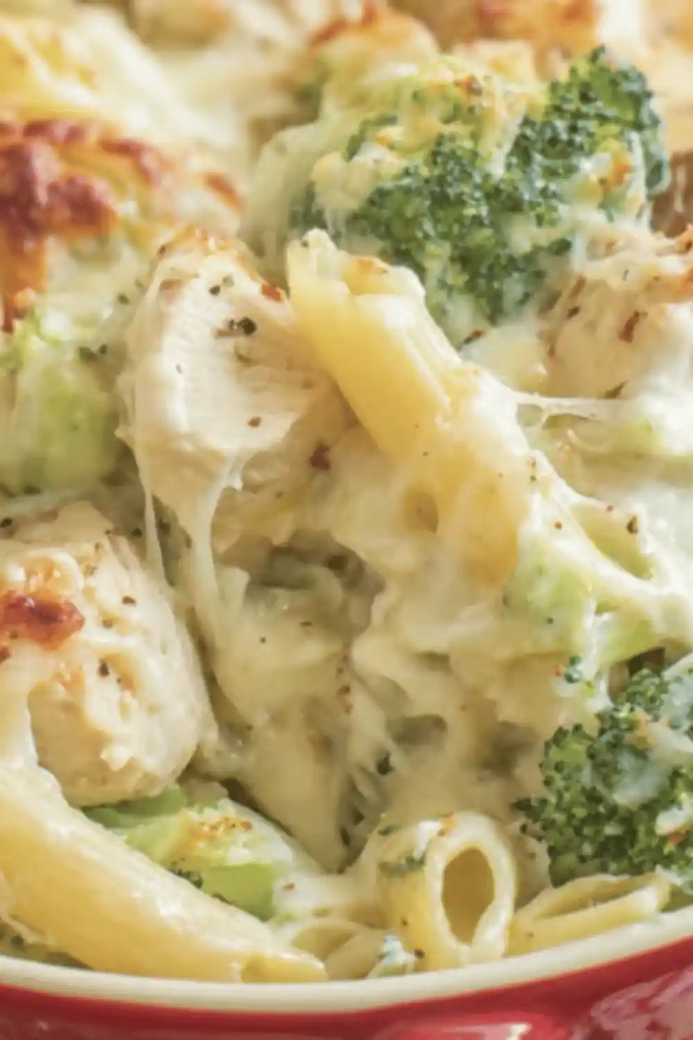 Cheesy Chicken Broccoli Pasta Bake with golden melted cheese in a casserole dish