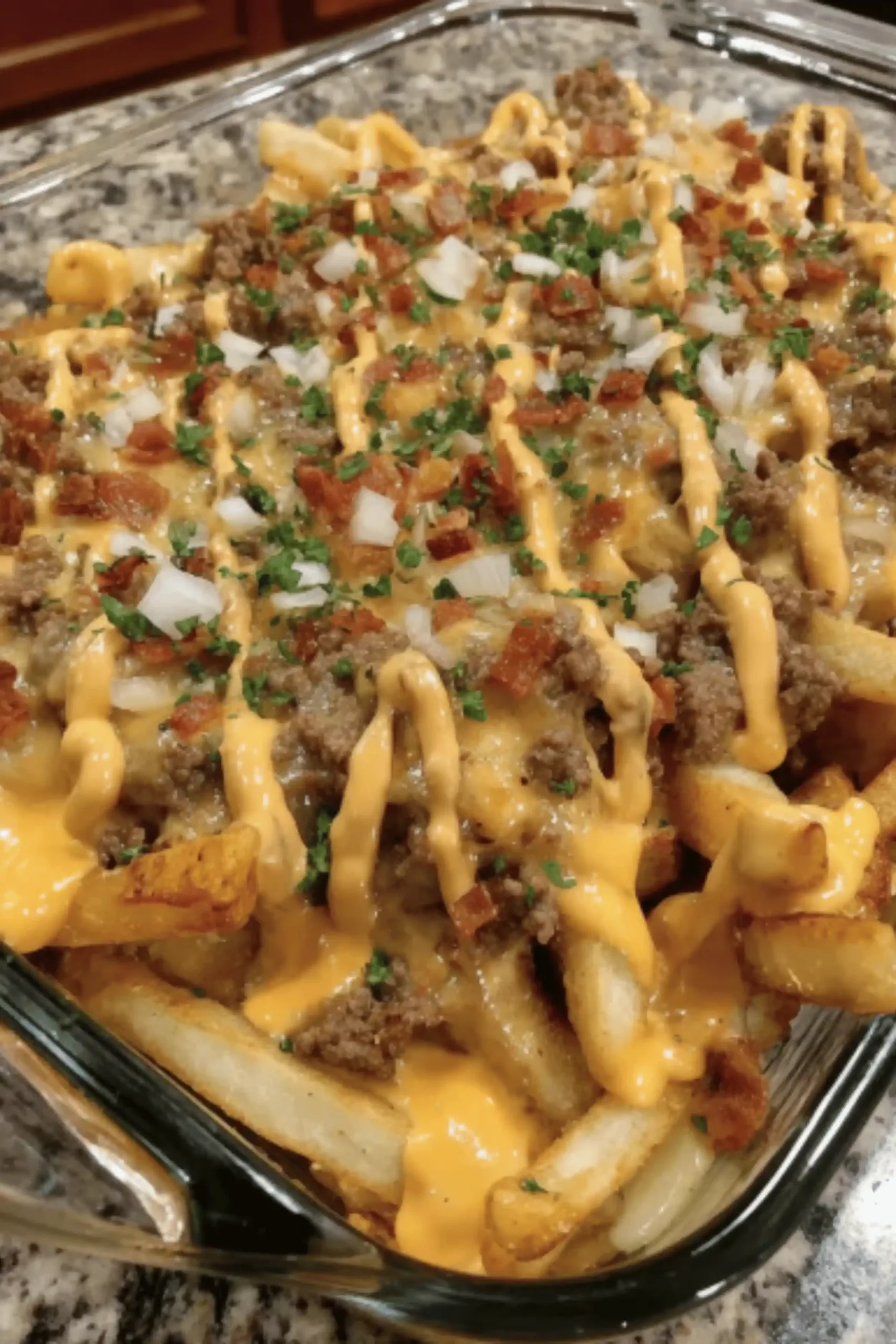 Cheeseburger French Fry Casserole topped with melted cheddar and crispy fries in a baking dish.