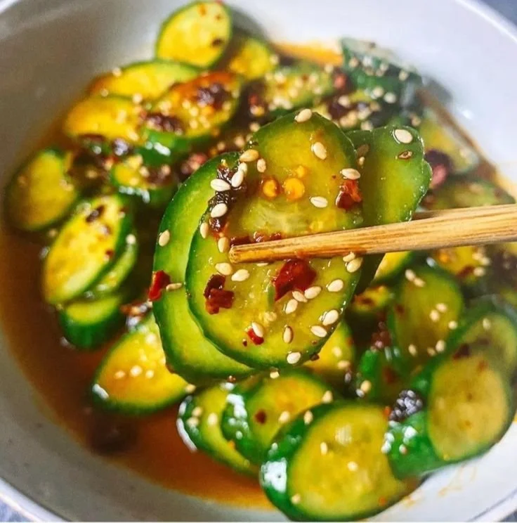 Bowl of Easy Asian Cucumber Salad with sesame seeds and fresh vegetables