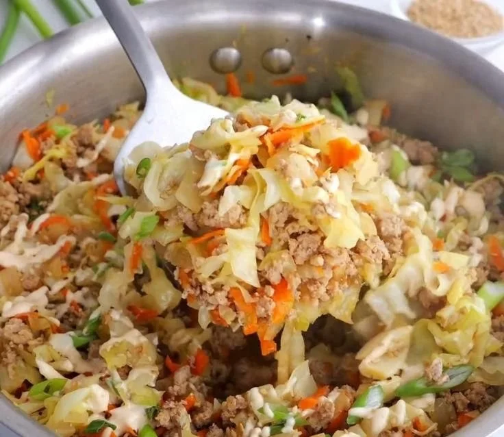Delicious egg roll in a bowl dish with colorful vegetables and savory sauce.
