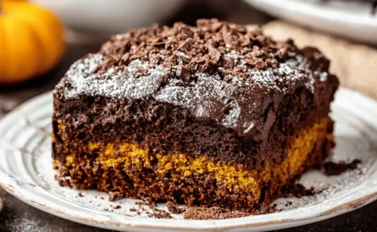 Delicious slice of Chocolate Pumpkin Cake topped with chocolate ganache and pumpkin seeds.