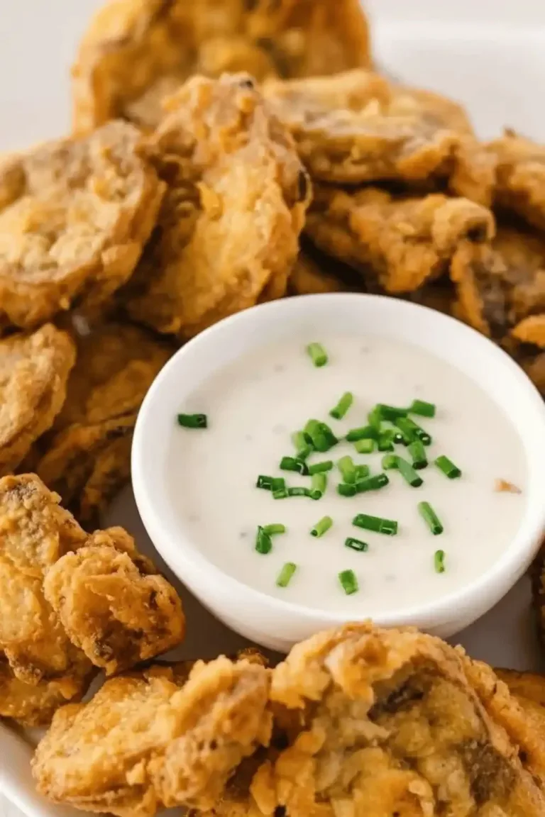 Deliciously crispy fried mushrooms served on a plate with herbs.