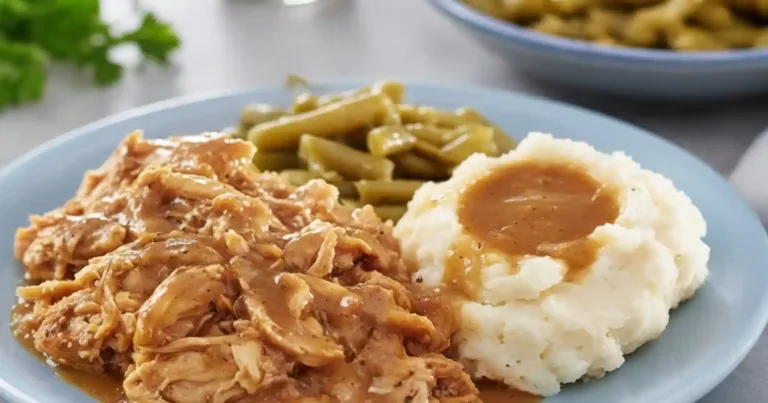Delicious plate of Mississippi Chicken garnished with fresh herbs.