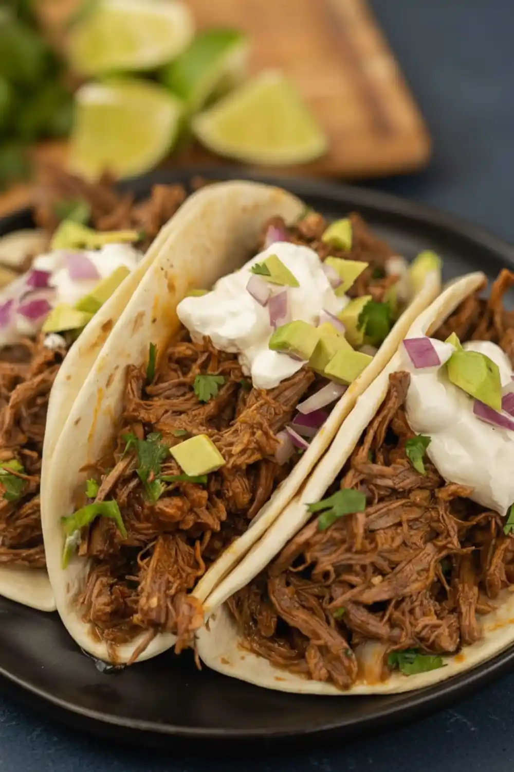 Delicious Crock Pot Mexican Shredded Beef Tacos served with fresh toppings