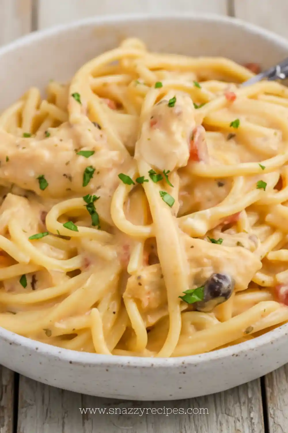 Crock Pot Cheesy Chicken Spaghetti with creamy sauce and pasta served in a bowl.