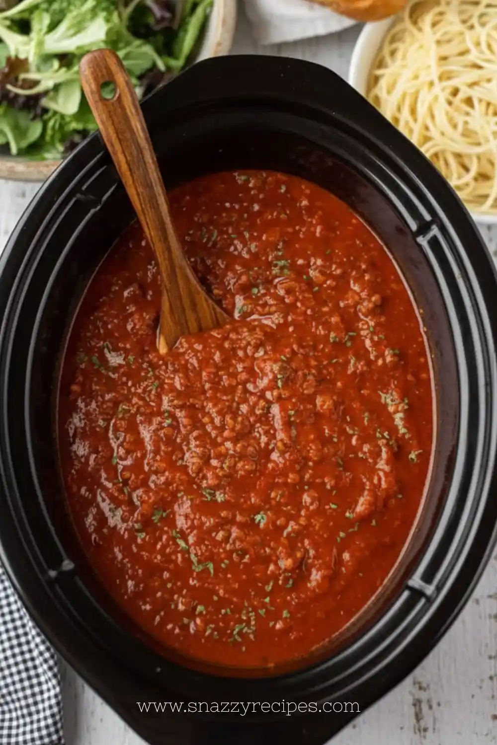 Crock Pot spaghetti sauce simmering in a slow cooker with fresh ingredients.
