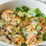 Delicious Coconut Lime Chicken served with fresh herbs and lime slices