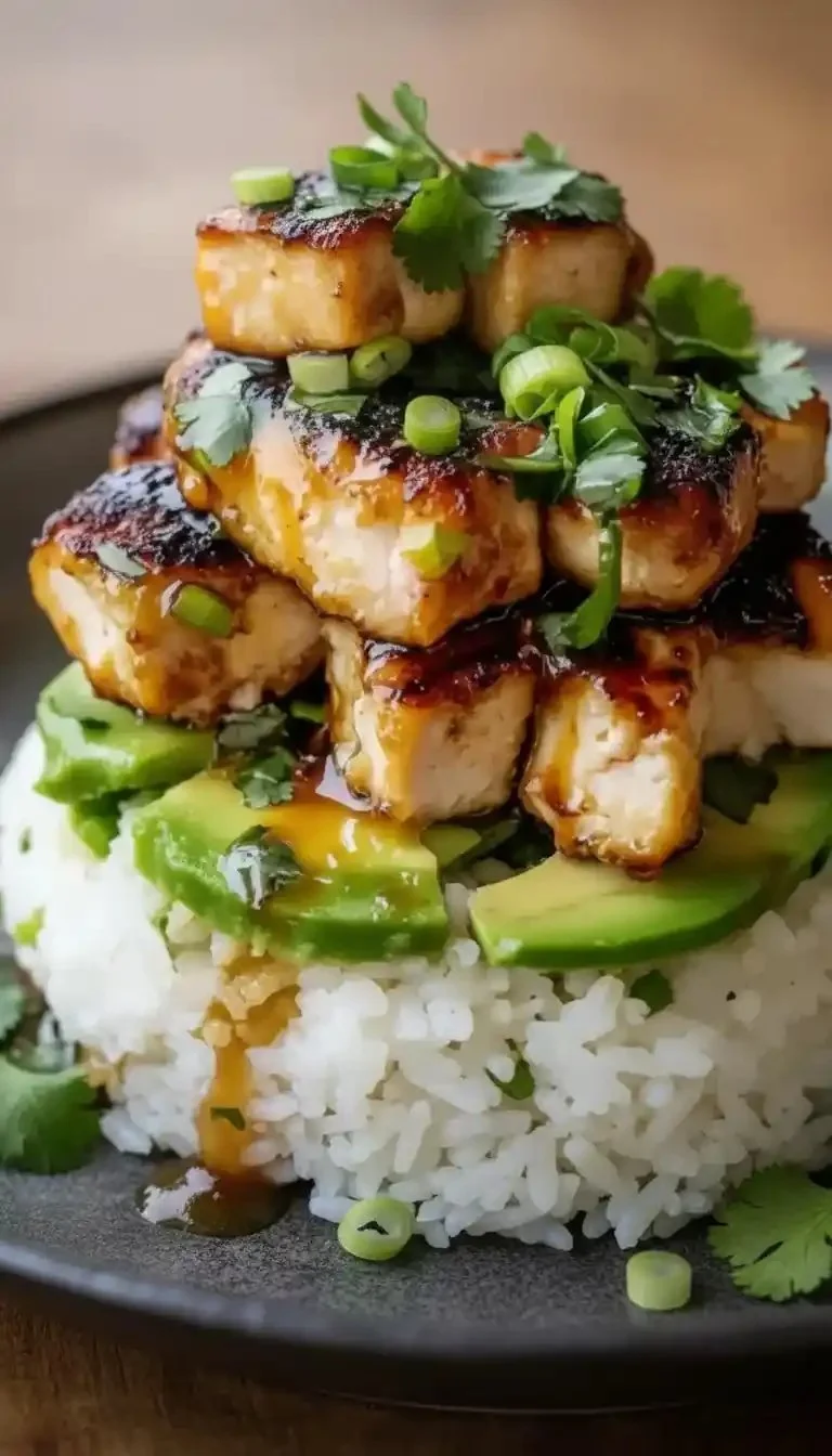 Delicious honey lime chicken served with avocado rice stack on a plate