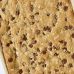 Delicious homemade oatmeal chocolate chip bars on a wooden table