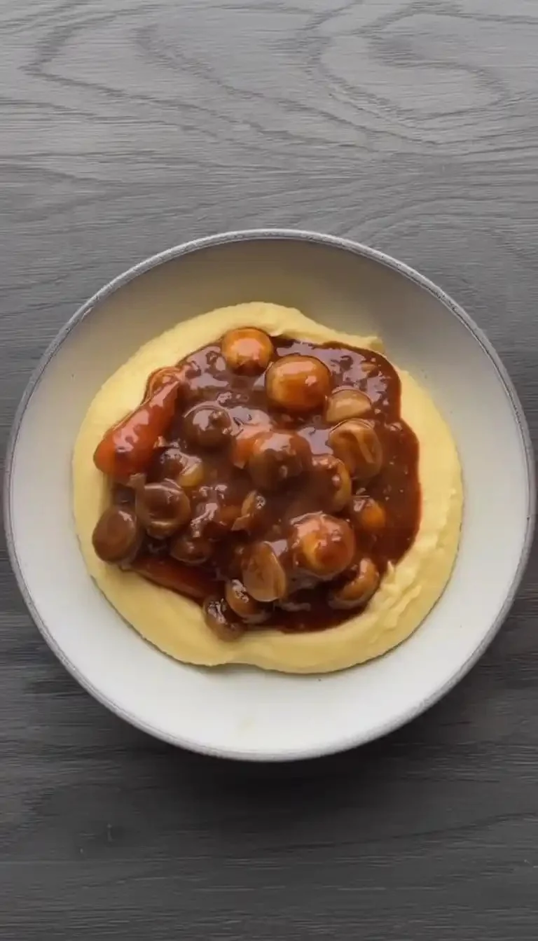 Delicious Mushroom Bourguignon served in a rustic bowl with fresh herbs.