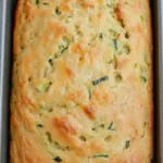 Baking savory zucchini quick bread on a wooden table