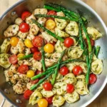 Pesto chicken served with tortellini and fresh veggies on a plate