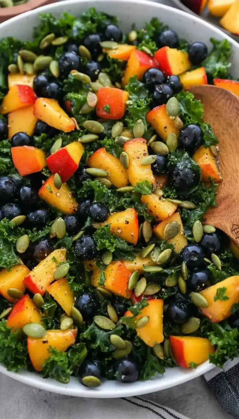 Summer Kale Salad with Peaches and Blueberries in a bowl